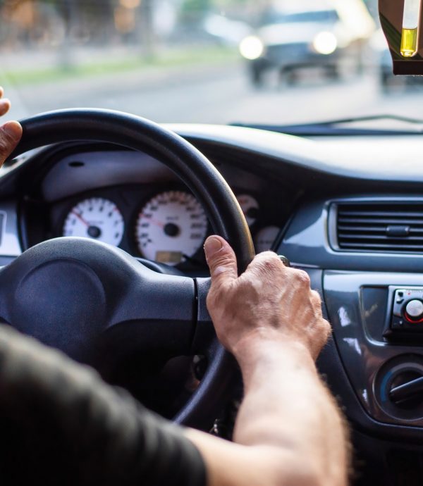 A man driving a car with cigarette